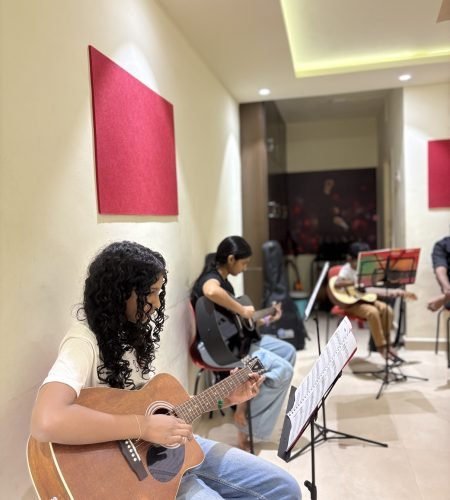 girls practicing guitar